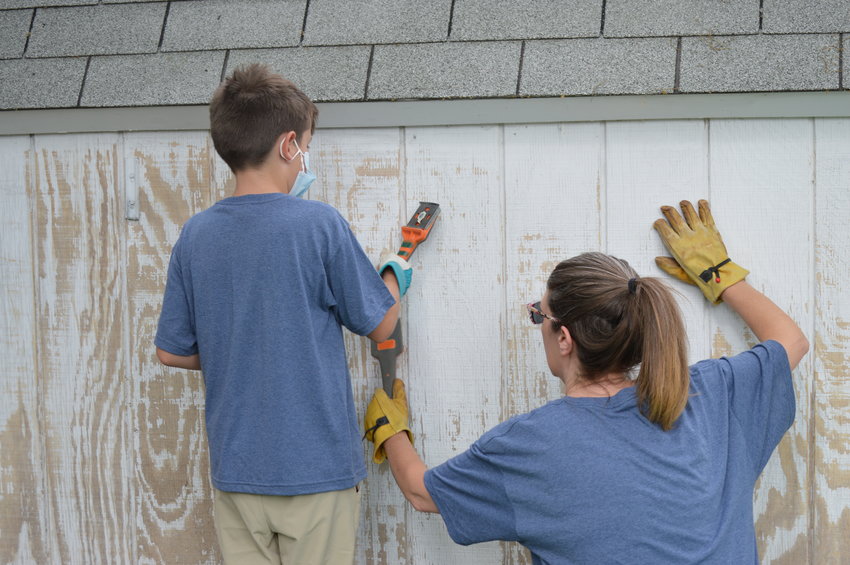 Christine Hart, an accountant for the City of Englewood, and her 10-year-old son, Liam Bibby, were among the volunteers at Kayleen Nichols' home on June 18, 2022. "As an Englewood employee, I just think it's important to be out here and support the community. And it's a good lesson for him," Hart said.